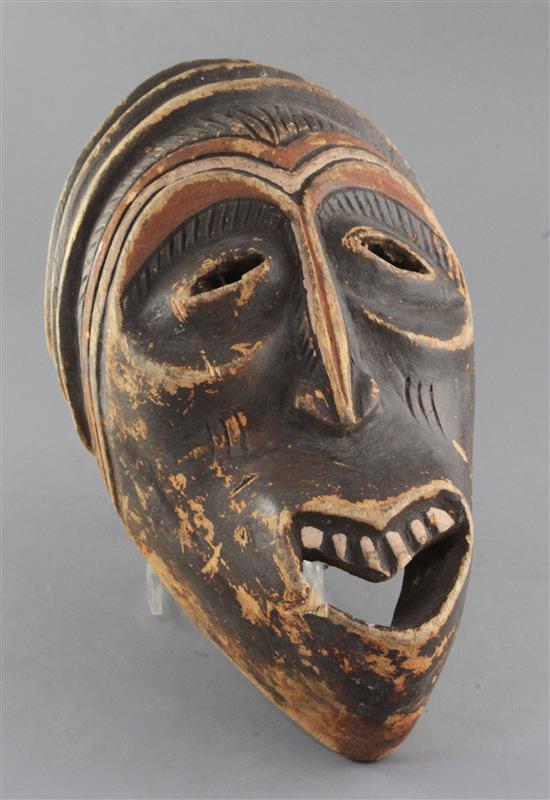 An African carved and stained wood mask, 36cm